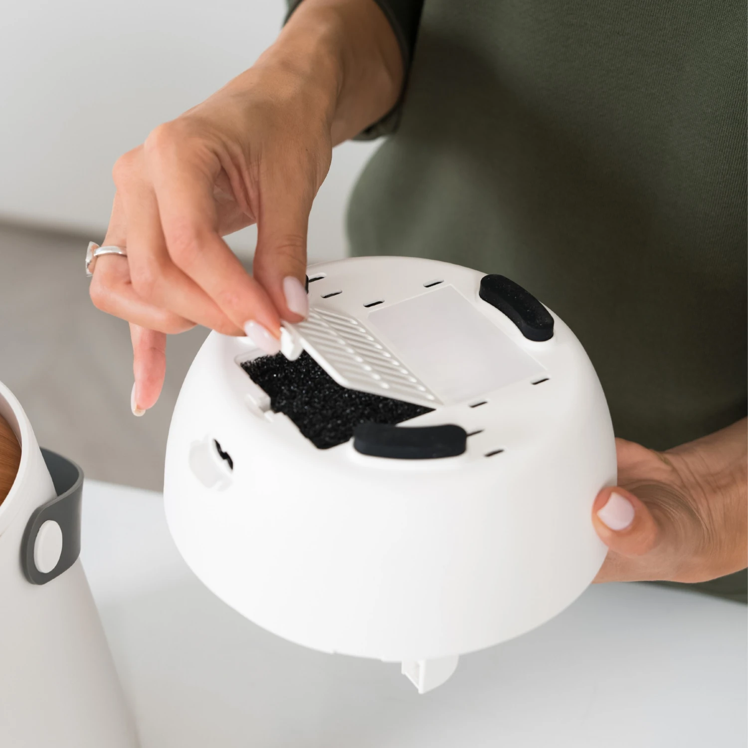 Placing the removable air filter into the base of the humidifier