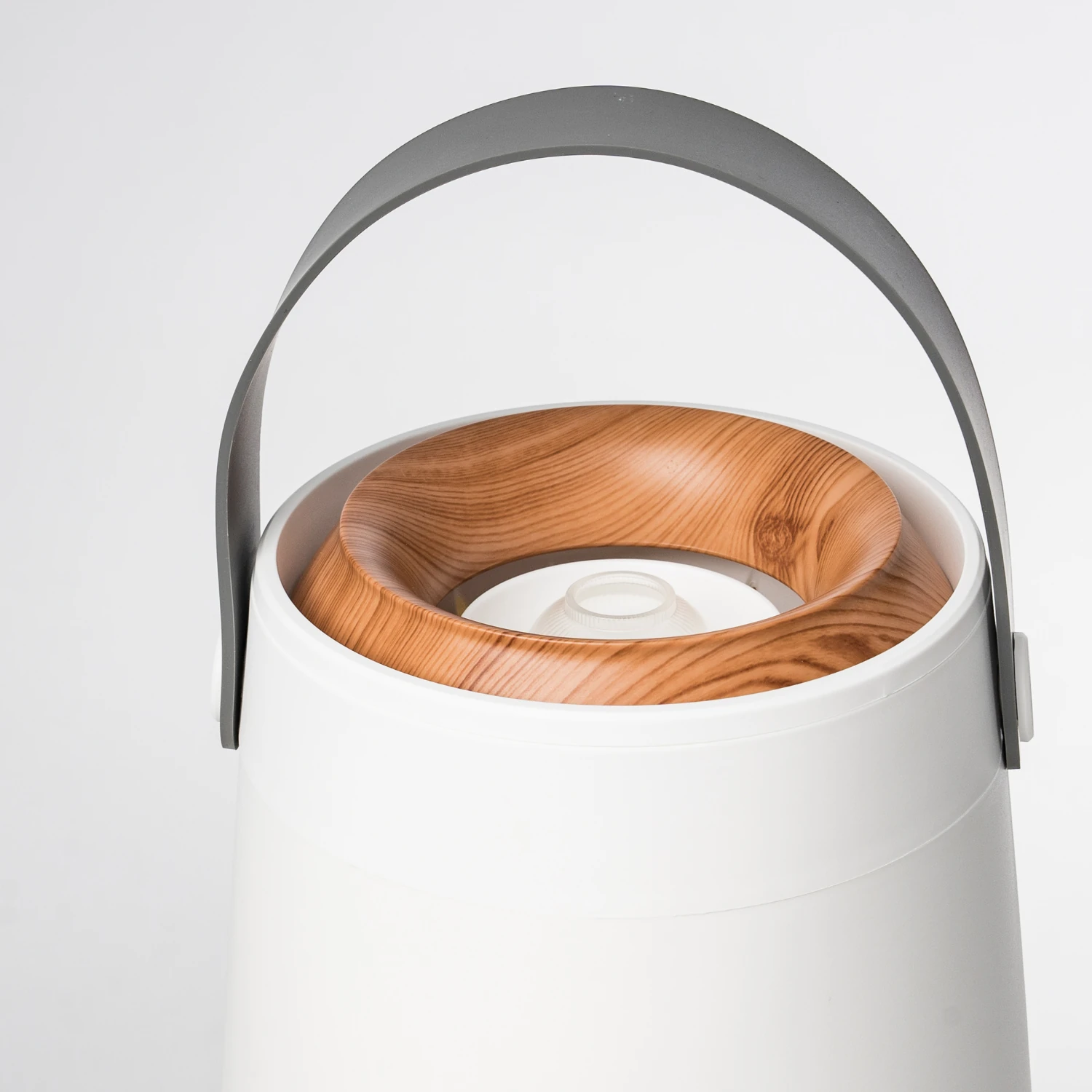 Close-up of the carry handle and wood-top lid of the humidifier